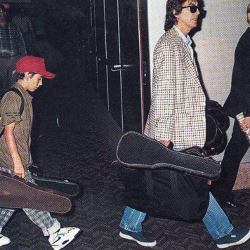 George Harrison with Red Cap (son, actually) carrying five extra ukes
